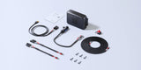 Everything supplied with the BLUETTI Charger 2 laid out: the charger, car battery cables, MC4 cables, the MC4 to XT60 cable, the bidirectional power cable, the 75A fuse, self-tapping screws and the user manual