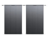 Two BLUETTI PV100 FX flexible solar panels standing side by side, as supplied in the twin pack, showing the cell grid, corner grommets and MC4 leads